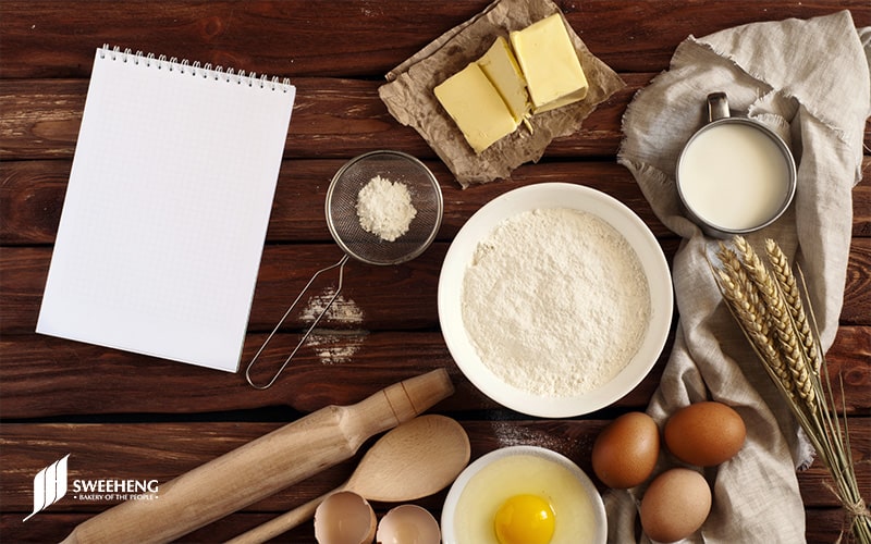 Various baking ingredients displayed on a wooden table.