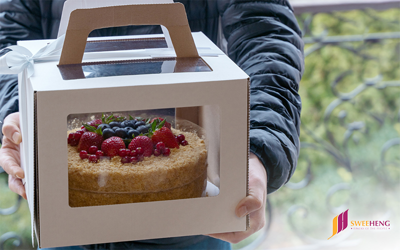 A delivery man completing a prompt pastry box delivery