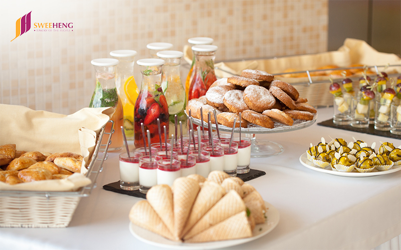 A buffet table with various food options, emphasizing the significance of pastries for successful events